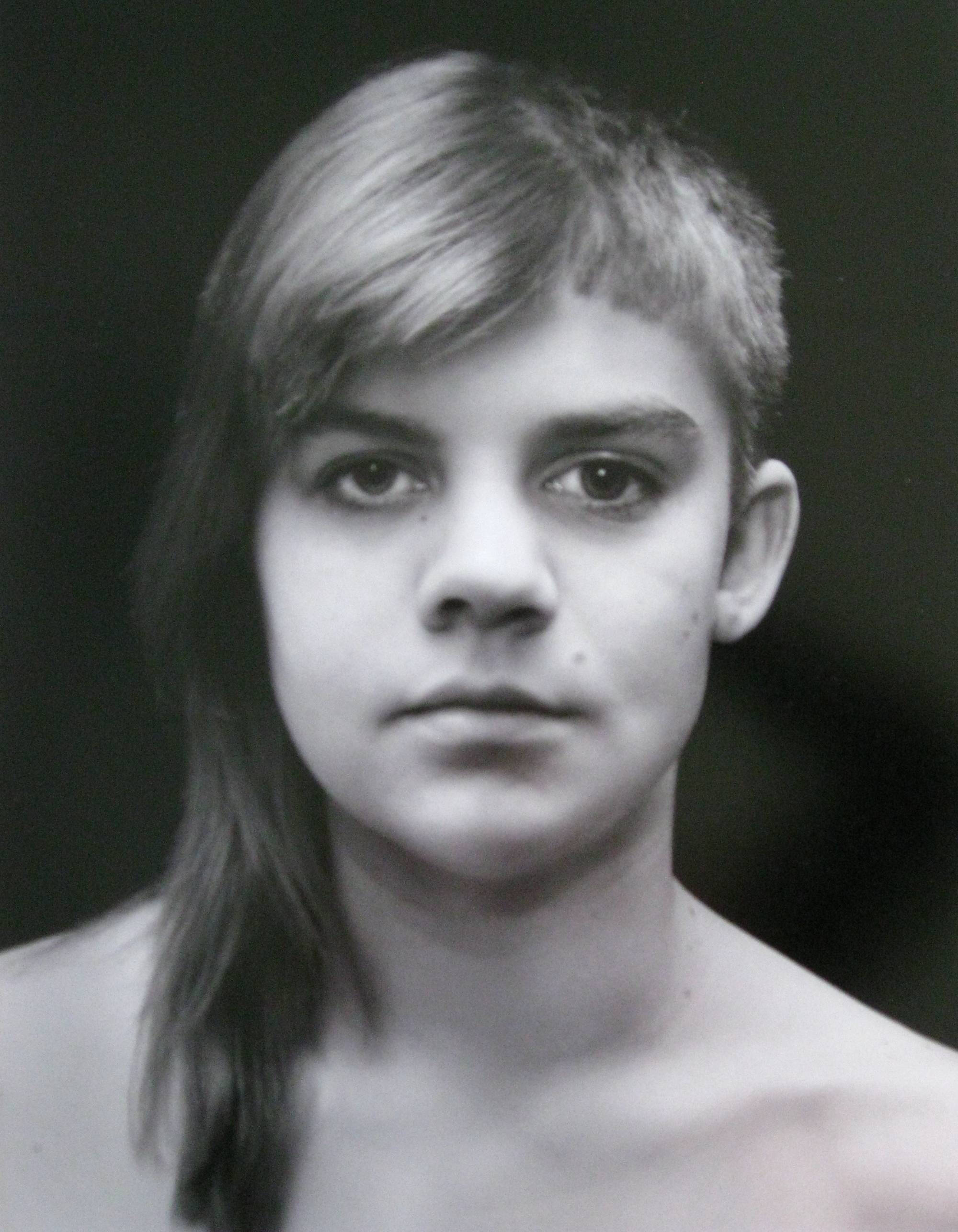 Black and white portriate photograph of someone with two different hair cuts.